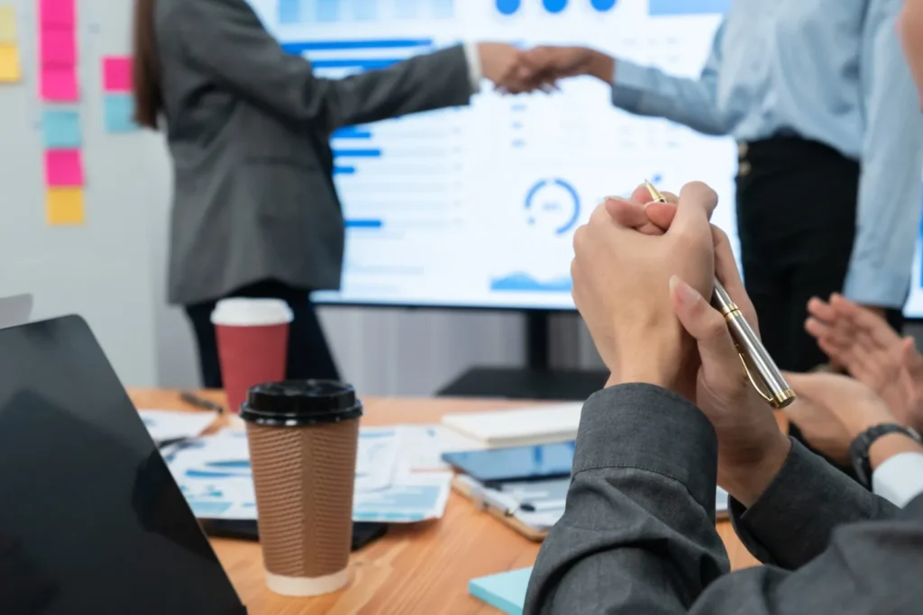Diverse Coworkers Celebrate Success With Handshake. Concord
