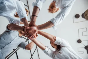 View From Below. Successful Business People Putting Their Hands Together